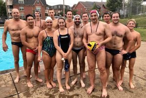 Water polo players standing for a photo after practice.